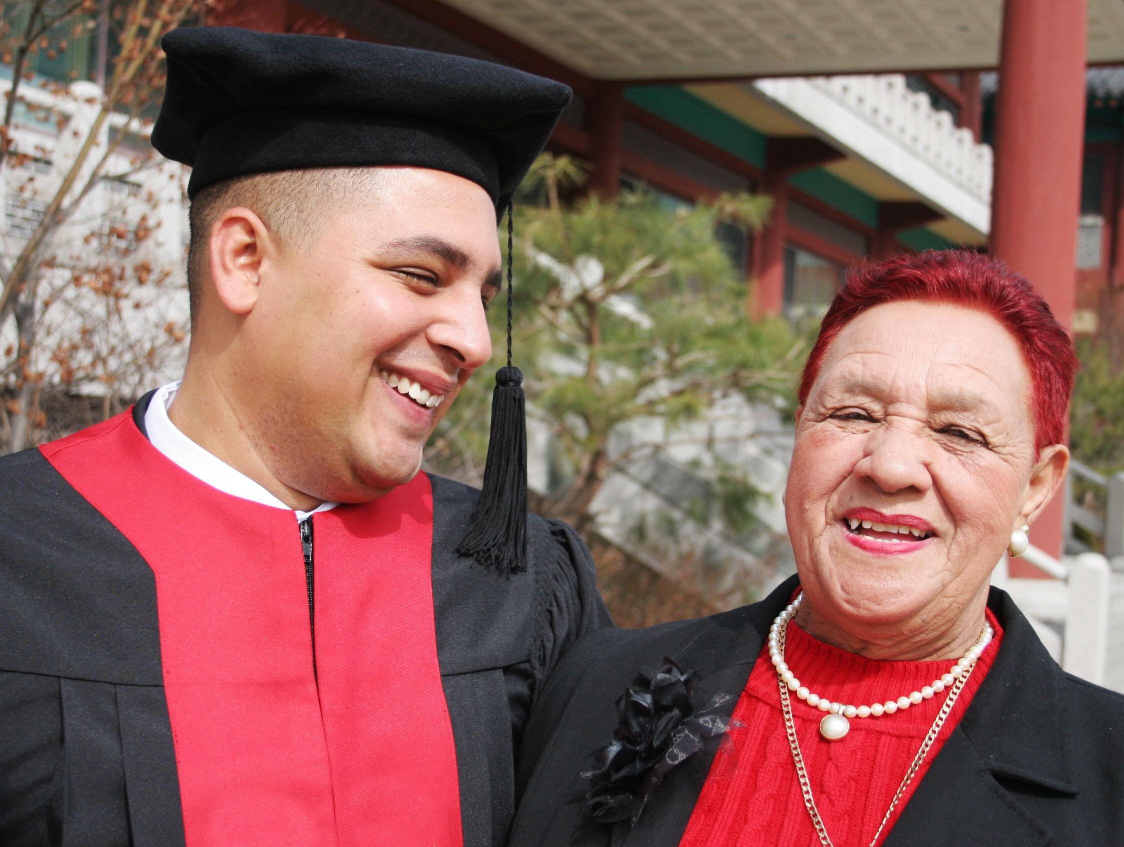 University graduate shares a moment with his grandmother - happy and successful